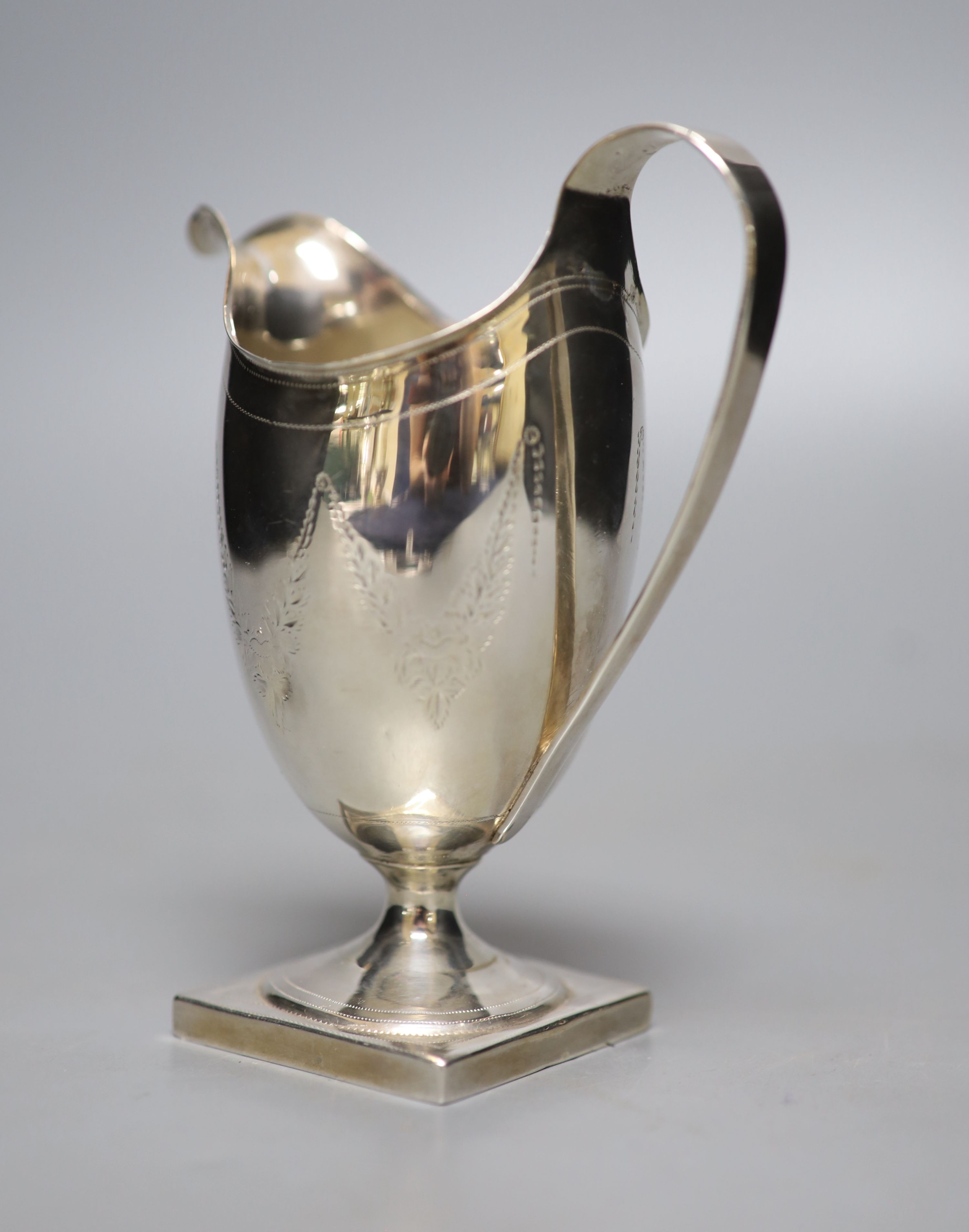 A George III engraved silver helmet shaped cream jug, Andrew Fogelburg, London, 1796, (a.f.), 13.5cm, 120 grams.